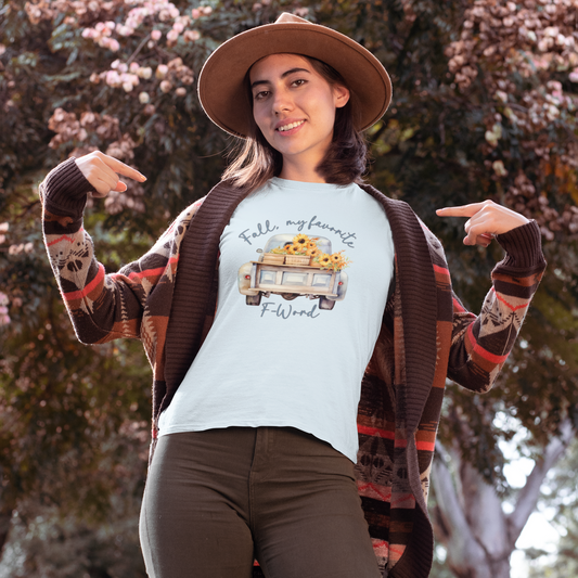 Shown is a woman wearing our "Fall, My Favorite F-Word" Women's T-Shirt! This playful design features the back end of an old-fashioned pickup truck filled with fall-colored flowers on a comfy relaxed fit short sleeve chambray sleeve t-shirt.